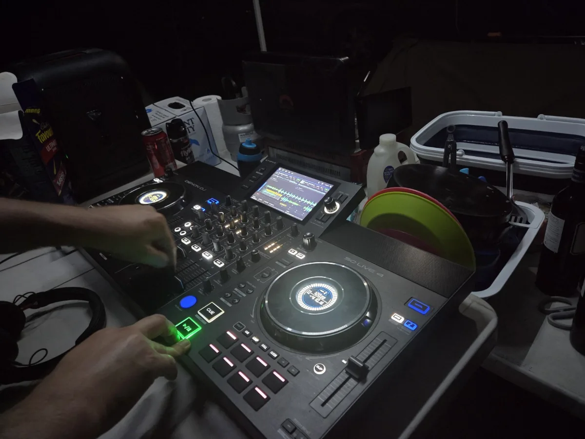 Denon SC LIVE 4 DJ controller operating on a camping table at night