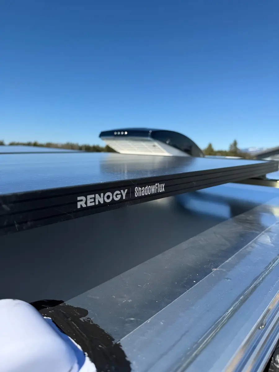 Close-up of a Renogy ShadowFlux solar panel mounted on a van roof