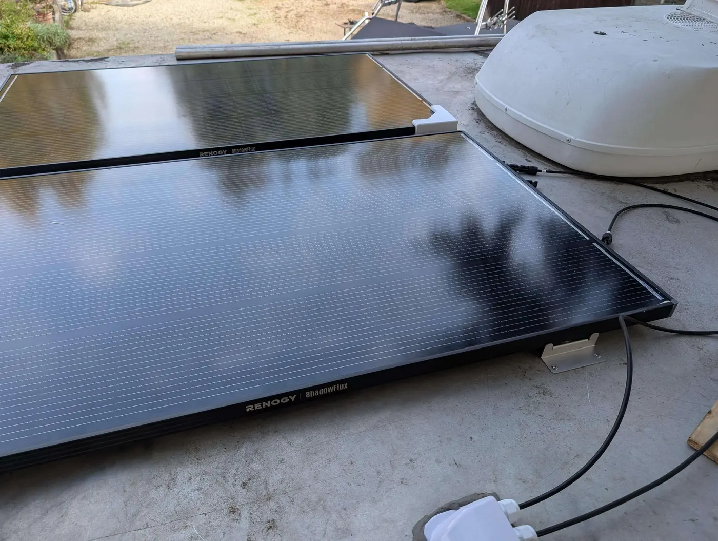 Renogy ShadowFlux solar panels installed beside a rooftop air conditioner