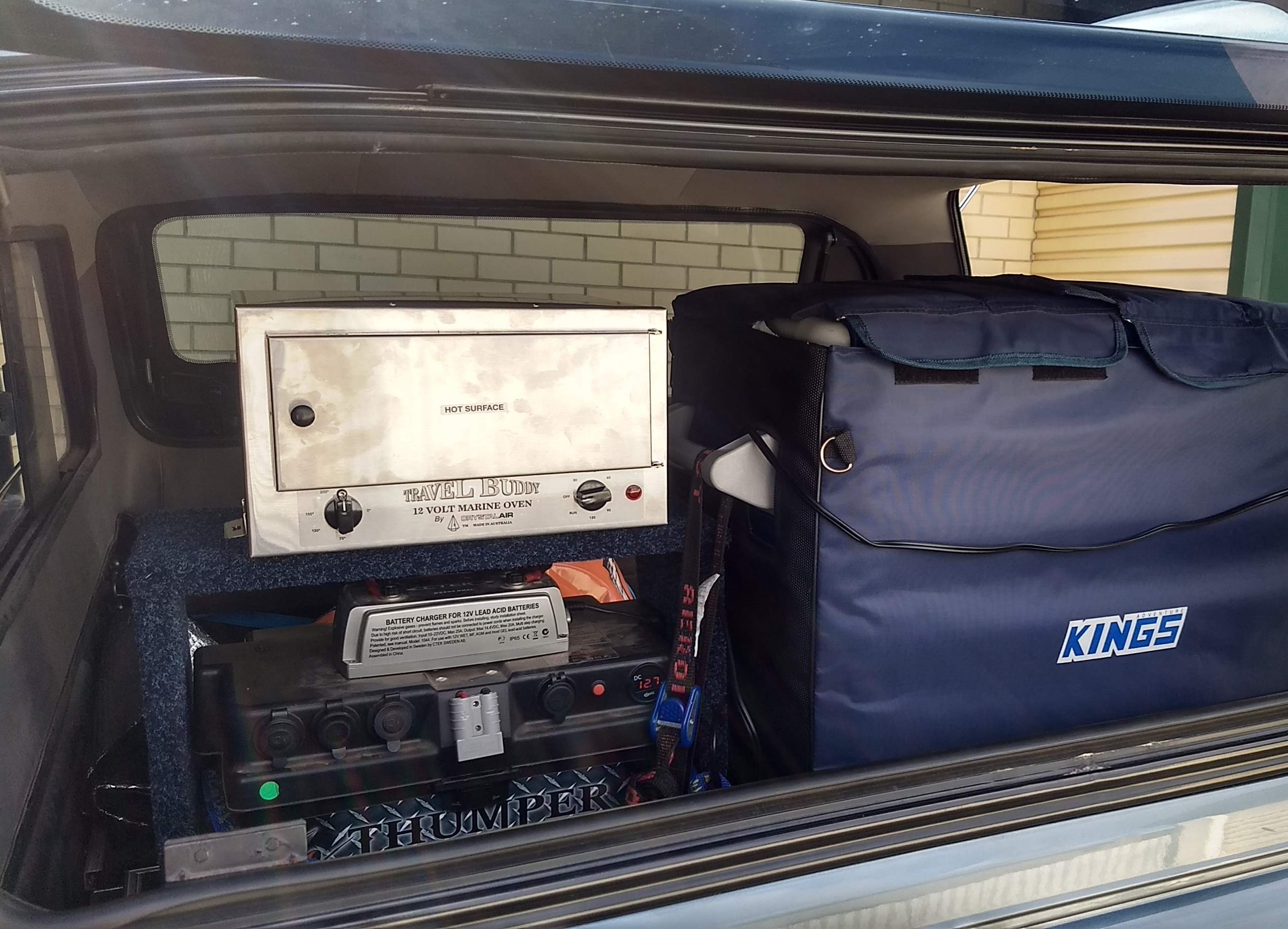 12V battery box, charger and fridge set up together in the back of a 4WD
